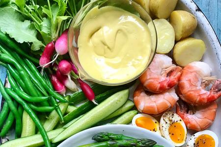 Aioli with a plate of vegetables, shrimp and potatoes