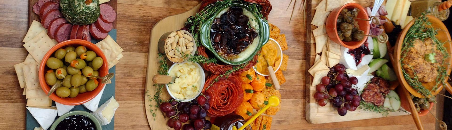 Charcuterie Boards with cheese, cold cut meats, olive oils, nuts, grapes and dips