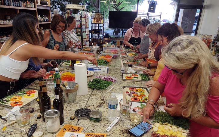 About a dozen women participating in cooking class